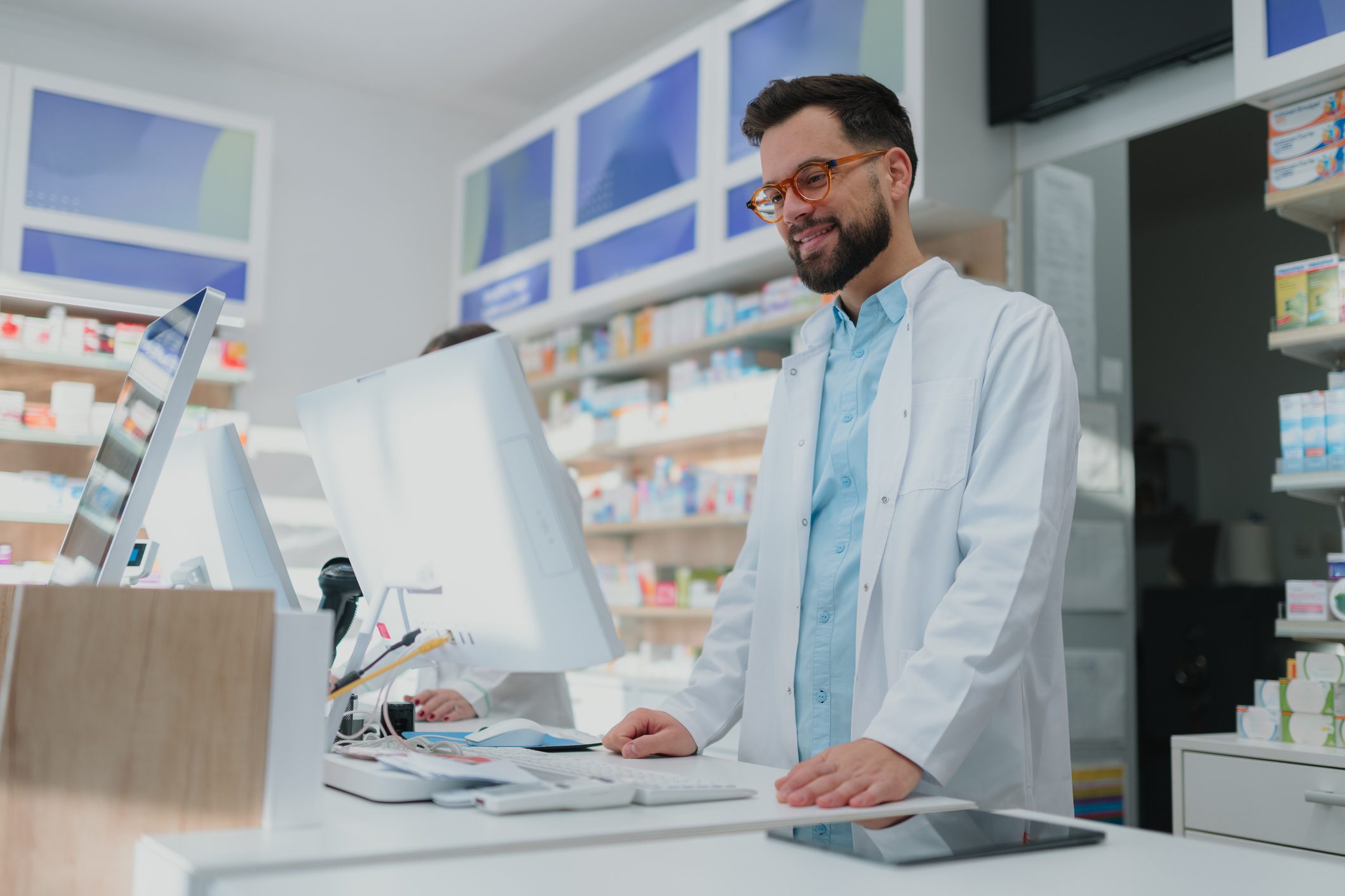 Pharmacist working at a pharmacy counter.