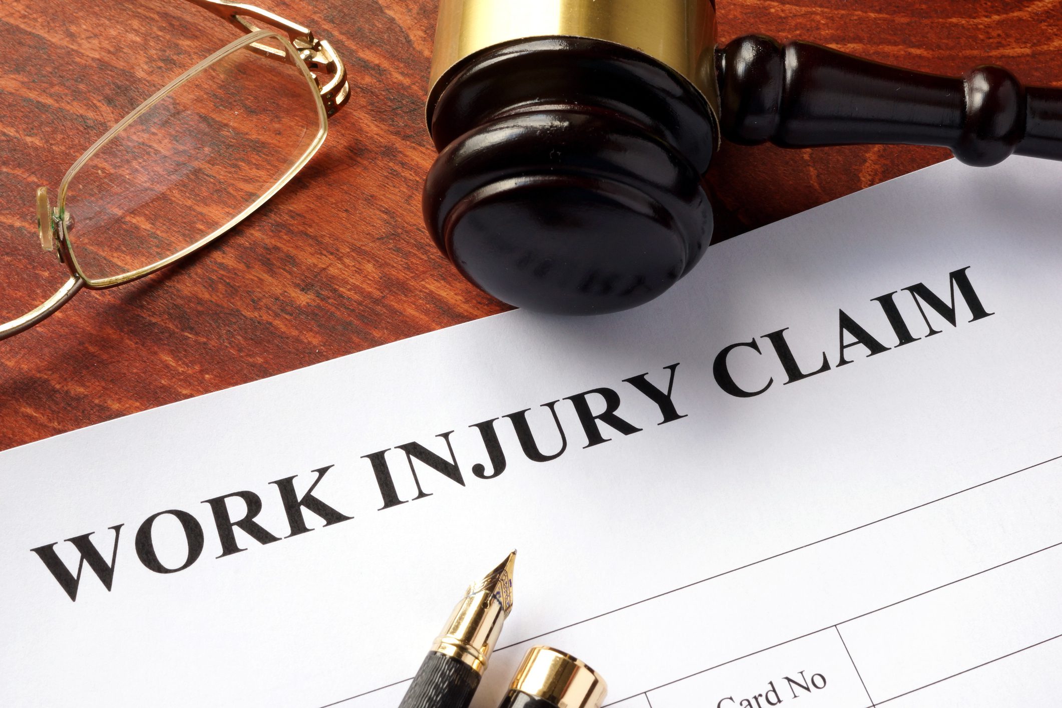 Work injury claim form with gavel.